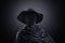 Creepy figure with old hat over dark