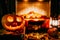 Creepy halloween pumpkin near a fireplace. Fire and dry leaves on the background. Jack of the Lantern, copyspace. Shoot