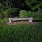 Creepy stone bench with nothing on it at night