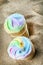 Creme brulee ice cream with bright rainbow colors in a waffle Cup on the sand