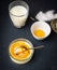 Creme brulee with spoon, glass of milk, egg yolk and sugar