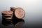 Creme-filled sandwich cookie on dark reflective background