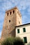 Crenellated tower olive tree and sky with white clouds in Monselice in the Veneto (Italy)