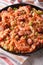 Creole food: jambalaya with shrimp and sausage close-up. vertica