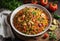 Creole jambalaya with rice, chicken meat, sausages and vegetables on wooden background