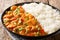 Creole shrimp Etouffee dish with celery, onion and pepper cooked in roux sauce served with rice close-up in a plate. horizontal