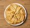 Crepe closeup, heap of thin pancakes on a dish, wood background