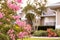 Crepe Myrtle Blossoms in front of southern home in select focus