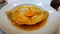 Crepe suzette, tasty pancakes with orange sauce on white plate, AI generative