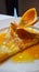 Crepe suzette, tasty pancakes with orange sauce on white plate, generative AI
