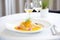 crepe suzette on white plate, fine dining setting