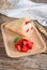 Crepes cake roll cream cheese with strawberry on wood plate.