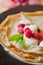 Crepes with cream and raspberry