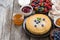 crepes, fresh berries and jam on a wooden background