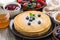 Crepes, fresh berries and jam on a wooden background, close-up