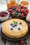 Crepes, fresh berries and jams, vertical, close-up