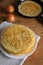 Crepes (Russian Blini) with onions on wooden background, top view. Homemade thin fresh crepes for breakfast