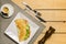 Crepioca - pancake of cassava tapioca with tomatoes, letuce and cheese on plate on wooden background