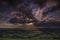 Crepuscular rays of sunlight shine onto fields in Dorset