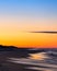 Crescent moon rising just before sunrise over a beach. Jones Beach State Park