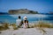 Crete Greece, Balos lagoon on Crete island, Greece. Tourists relax and bath in crystal clear water of Balos beach.