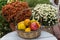 CRETE, GREECE - November, 2017: Wicker basket with fruits on a background of chrysanthemums