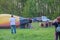 Crew inflate hot air balloon in forest meadow in Ukraine, Europe