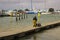 A crew member pushes a buggy along a floating pontoon at the harbour at Warsash in Hampshire as he helps unload a trawler