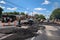 crew, performing intricate asphalt repair in busy intersection