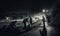 A crew of road workers repairing a highway at night