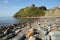 Criccieth rocky beach Wales UK historic coastal town in summer with blue sky on a beautiful day