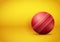 Cricket ball on bright orange background