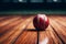 cricket players ball rests on wooden basketball court