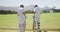 Cricket players doing a check on a pitch