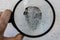 crime investigation, a magnifying glass and the fingerprint on the surface texture