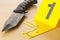 Crime scene investigation CSI evidence marker with knife on wood floor background at crime scene - police, evidence or forensic