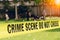 Crime scene tape and blurred law enforcement team background