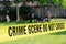 Crime scene tape and blurred law enforcement team background