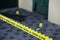 Crime scene tape for covering the area cordon. Yellow tape with blurred forensic law enforcement background in cinematic tone