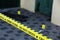 Crime scene tape for covering the area cordon. Yellow tape with blurred forensic law enforcement background in cinematic tone