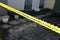 Crime scene tape for covering the area cordon. Yellow tape with blurred forensic law enforcement background in cinematic tone