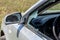 Criminal incident. Hacking a car. Broken driver`s side window of car. Thieves smashed window of car with fragments inside, glass