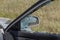 Criminal incident. Hacking a car. Broken driver`s side window of car. Thieves smashed window of car with fragments inside, glass