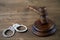 The criminal law. Wooden judge`s gavel. Handcuffs