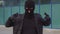 Criminal man thief or robber in mask showing sign og the horns at camera.