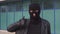 Criminal man thief or robber in mask shows thumb up.