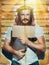 Criminal suspect Jesus holds a laptop and a bottle of alcohol in his hand, is photographed against the background of growth wall