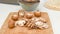 Crimini mushroom slices close up on wooden cutting board, preparation process