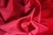 Crimson jersey fabric in soft folds