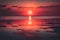 crimson sky sunset the hot sun goes beyond the horizon of the sea Generative AI